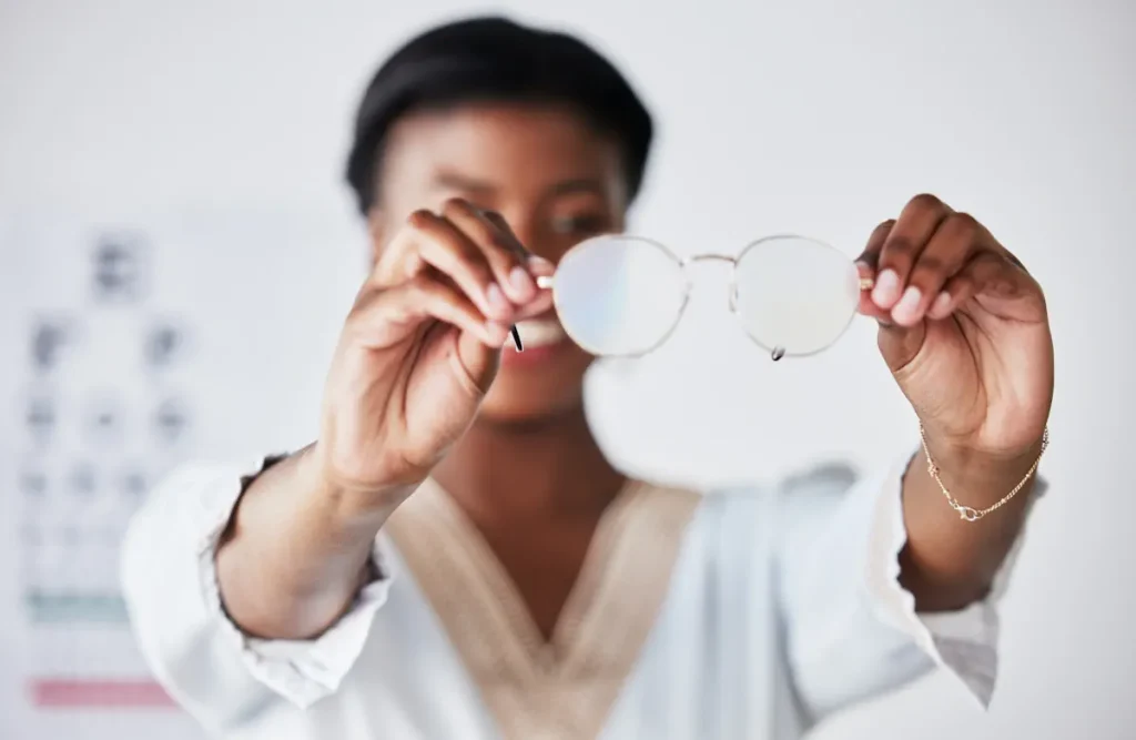 Une jeune femme qui montre des lunettes avec des verres rondes