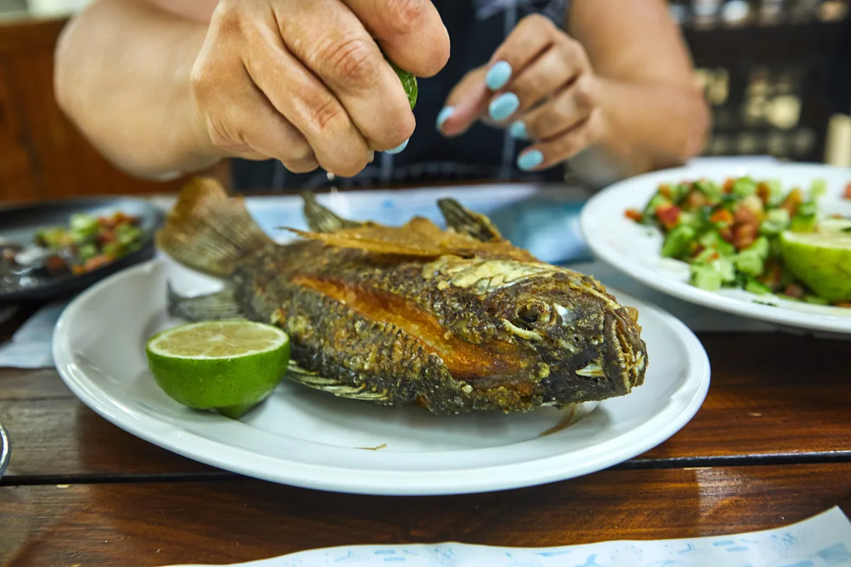 Une personne qui mange du poisson pour un meilleur apport en vitamine B12